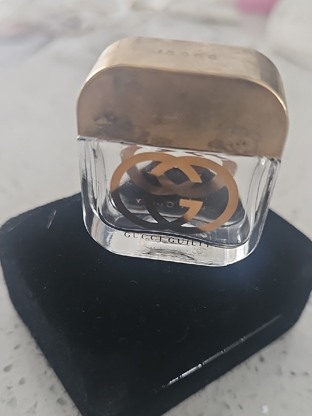 Gucci clear mini bottle with gold logo and cap